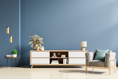modern-interior-of-living-room-with-cabinet-and-armchair-on-dark-blue-wall-background--e1623048120654